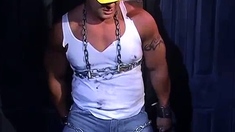 Muscular construction worker is bound up with chains