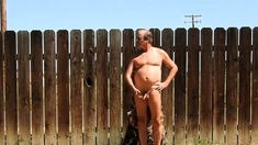 A daddy parading around naked in his backyard.