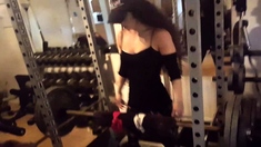Fit babe working out at a gym with heavy weights